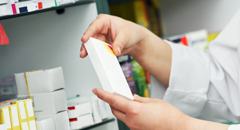 Pharmacist holding box of medication